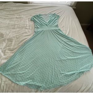 Turquoise dress with polka dots and a mild stripe pattern.